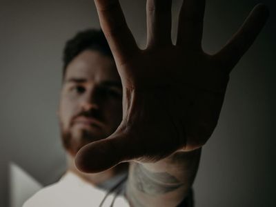 Close-up of a hand gripping a kettlebell, showing texture and focus.