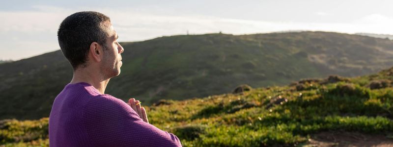 Man seen from the side, in a moment of calm focus between exercise sets.